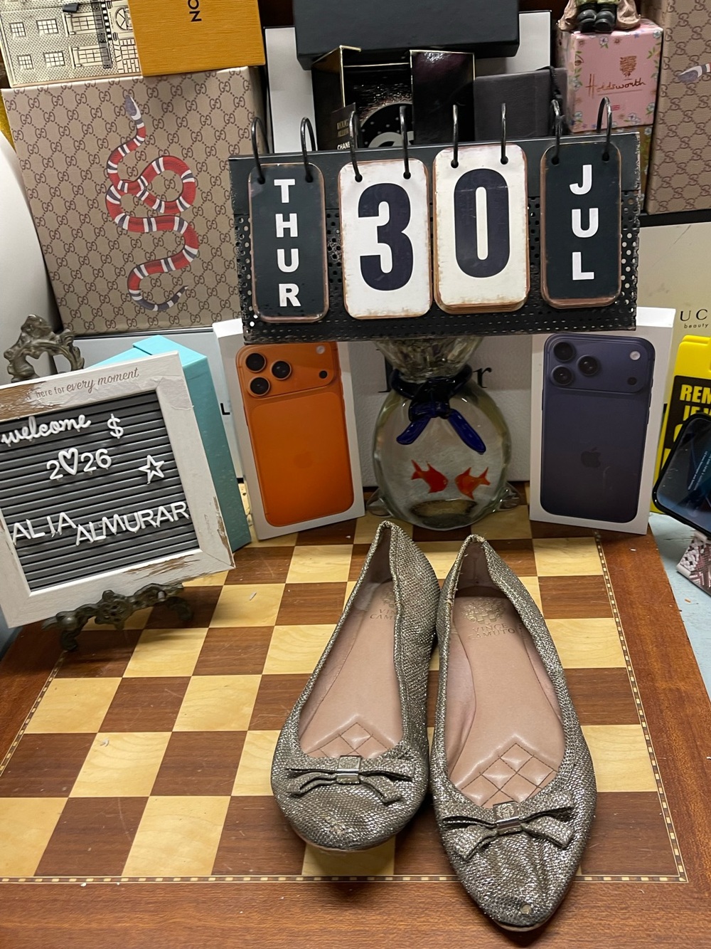 Vince Camuto metallic taupe flats feature a pointed toe and a small bow detail.